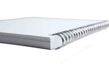 Spiral-bound notebook with blank pages, slightly angled view, showing metal binding