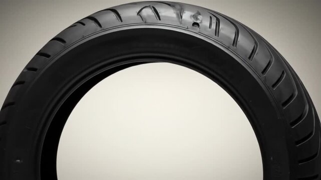 Motorcycle tire showcasing its tread pattern from multiple angles and viewpoints