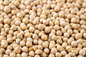 Raw dehydrated soybeans texture background top view.