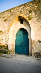 Fototapeta premium Aged stone archway with teal door