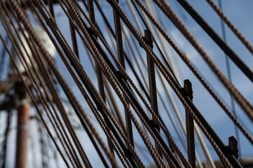 Complex network of rigging and ratlines on a vintage tall ship. Concept of connection, strength, and teamwork.