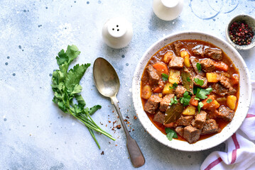 Goulash (meat stew with tomatoes and paprika) - traditional dish of hungarian cuisine .Top view with copy space.