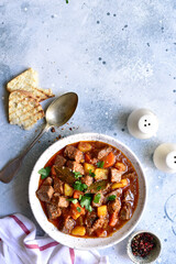 Goulash (meat stew with tomatoes and paprika) - traditional dish of hungarian cuisine .Top view with copy space.