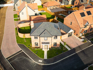 Drone view of a newly completed, detached family home seen on an imposing corner plot location....
