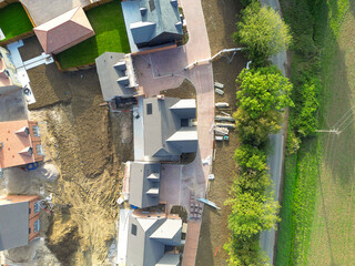 Drone top down view of in a row, nearly completed detached and first time buyer homes seen on a...