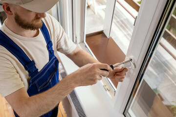 Repairman installs a PVC window frame for energy-efficient home improvement