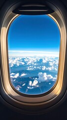 Airplane window view of clouds and mountains (1)