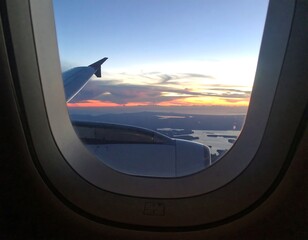 Airplane window view of sunset over landscape