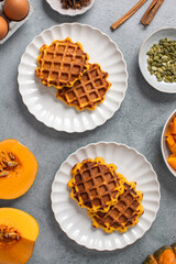 Autumn breakfast with pumpkin waffles and honey on a rustic table setting