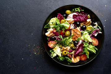 Green salad with grilled chicken fillet. Top view with copy space.