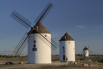 Three windmills in a row in Mota del Cuervo, La Mancha, Spain