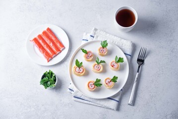 Omelette egg roll with imitation crab meat filling, tamagoyaki, in a plate