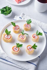 Omelette egg roll with imitation crab meat filling, tamagoyaki, in a plate