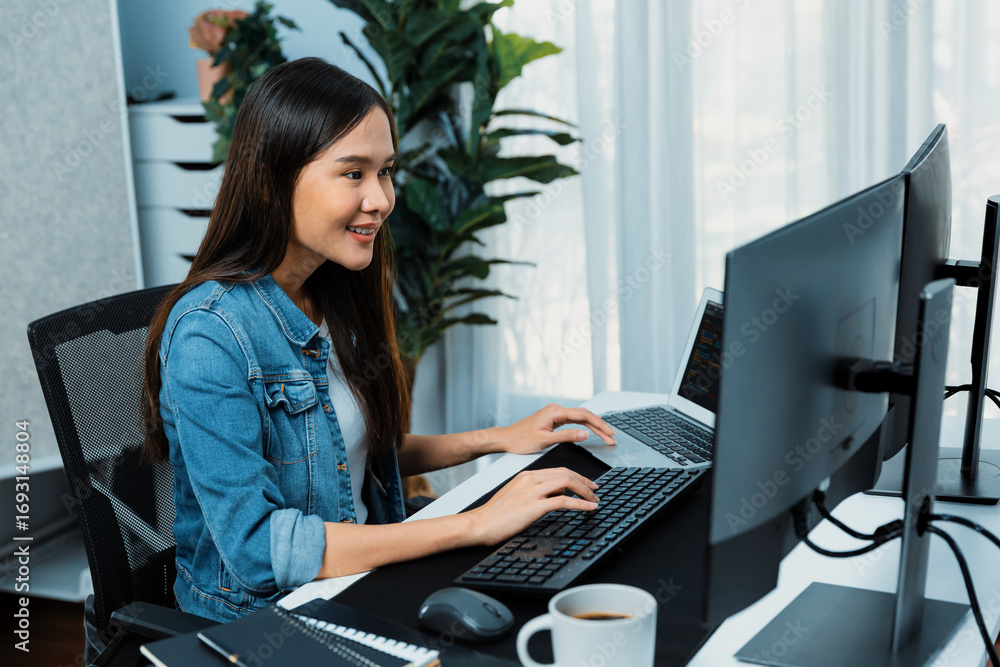 Poster smiling young asian it developer working software development information on pc screens and laptop, 