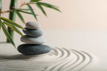 Obraz premium Zen garden: stacked smooth stones in serene sand with bamboo leaves
