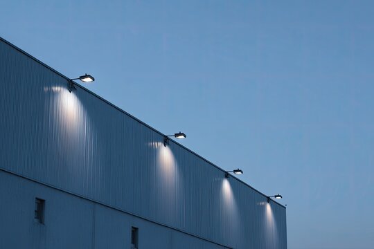 Industrial building at dusk with spotlights