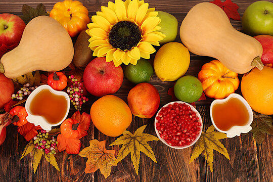 Thanksgiving banner, autumn background with apples, pomegranates, pumpkins, honey, grapes, flowers under sunflowers and leaves on wooden table, harvest concept, healthy natural food advertising, - Powered by Adobe