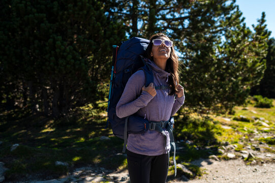 Female traveler looking up quietly inspired by light and mountain silence in nature.