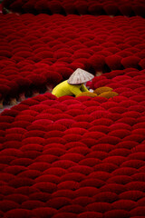 Traditional incense stick production with worker in Hanoi vietnamese village
