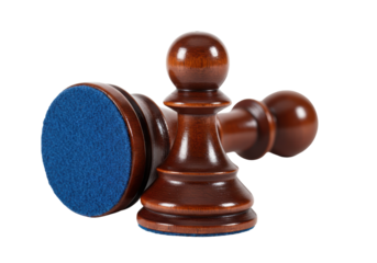 Isolated wooden pawns from a chess set laying on their sides, awaiting a new game to begin