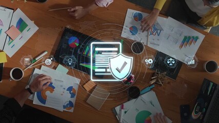 A diverse business team engages in a collaborative meeting centered on data analytics, emphasizing cybersecurity elements in a modern office space. Raster - Powered by Adobe