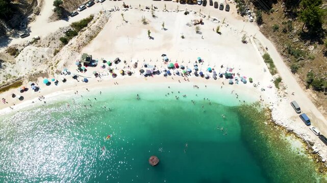 Porto Vathy beach, sand and umbrellas on beach, Thassos Island, Greece. One of the most beautiful beaches in Greece. Amazing beach with clear blue water. Aerial panoramic drone view from above, top vi
