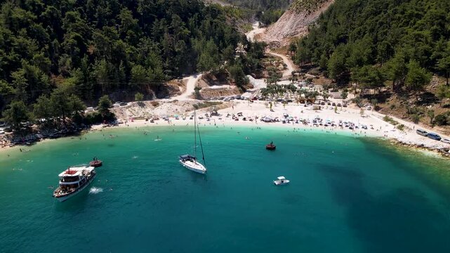 Porto Vathy beach, sand and umbrellas on beach, Thassos Island, Greece. One of the most beautiful beaches in Greece. Amazing beach with clear blue water. Aerial panoramic drone view from above, top vi