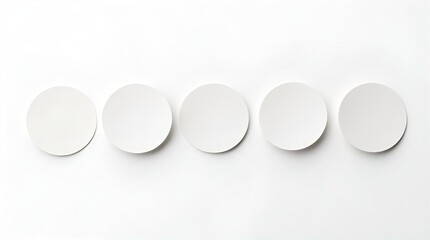 Five identical white round blank circles uniformly aligned horizontally on a bright, clean white background, a minimalist top-down view for simple design or product mockups.