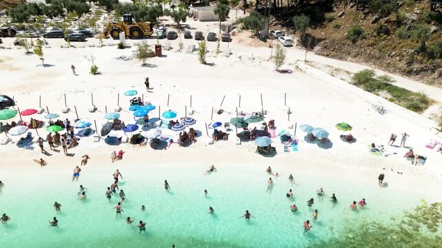 Porto Vathy beach, sand and umbrellas on beach, Thassos Island, Greece. One of the most beautiful beaches in Greece. Amazing beach with clear blue water. Aerial panoramic drone view from above, top vi