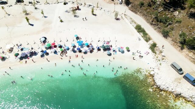 Porto Vathy beach, sand and umbrellas on beach, Thassos Island, Greece. One of the most beautiful beaches in Greece. Amazing beach with clear blue water. Aerial panoramic drone view from above, top vi