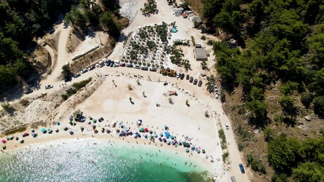 Porto Vathy beach, sand and umbrellas on beach, Thassos Island, Greece. One of the most beautiful beaches in Greece. Amazing beach with clear blue water. Aerial panoramic drone view from above, top vi