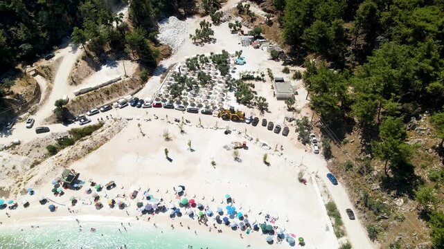 Porto Vathy beach, sand and umbrellas on beach, Thassos Island, Greece. One of the most beautiful beaches in Greece. Amazing beach with clear blue water. Aerial panoramic drone view from above, top vi
