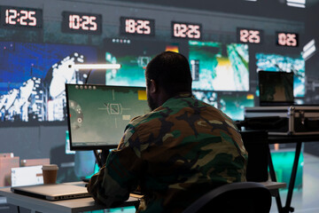 Air defense division operative using radar on computer to detect ballistic missiles. Army soldier...