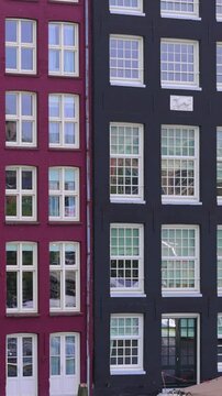 Holland, Amsterdam Damrak canal houses with scenic bridges in historic center, UNESCO Heritage site.