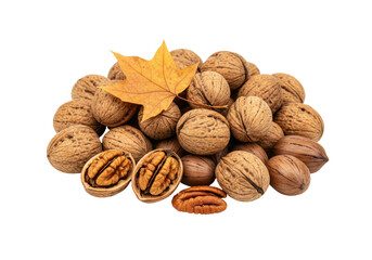 Isolated pile of walnuts with yellow maple leaf and cracked shell; autumn harvest bounty