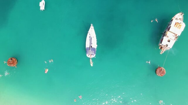 Yachts in sea on Porto Vathy beach, Thassos Island, Greece. Amazing beach with clear blue water. Aerial panoramic drone view from above, top view from drone. Summer holidays Europe
