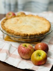 Homemade Apple Pie on a Towel with Apples