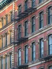 an old building with metal fire escapes in front in Tribeca, Manhattan, New York