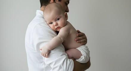 Adorable baby resting peacefully in dad's arms, a tender moment of love and care, perfect for family blogs, parenting articles, or heartwarming advertisements showcasing connection