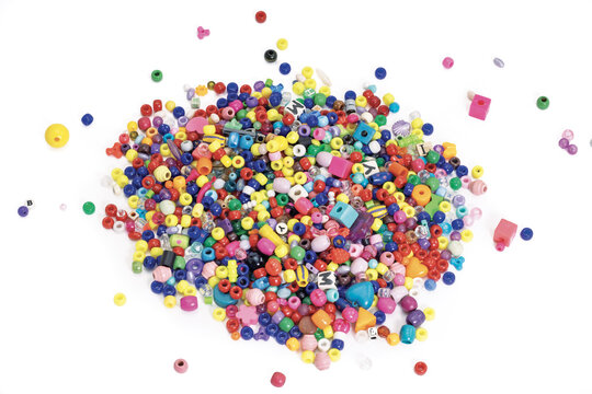 A Large Pile of Small, Colorful Plastic Beads Isolated on White