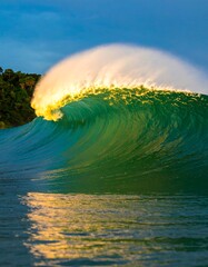 Powerful, vibrant turquoise wave at sunrise
