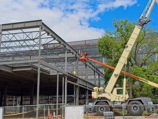 Building construction site with boom lift, hydraulic truck crane