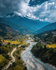 Aerial View Of Mountain Valley With River And Village