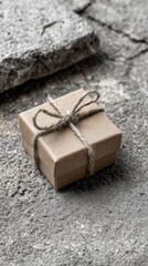 Simple Gift Box Wrapped In Kraft Paper On Gray Stone Background