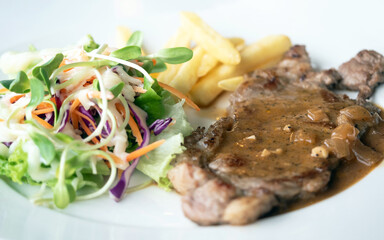 Close up of Grilled beef steak, boiled french fries and vegetable salad;Selective focus