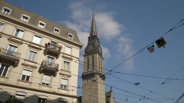 sunny day zurich city center residential apartment building front church tower slow motion up view 4k switzerland