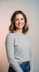 Young Smiling Woman Wearing Light Gray Sweater Standing Against Soft Pastel Background