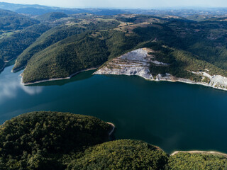 Aerial view of Rovni Lake reservoir and surrounding hilly landscape in Serbia. g.