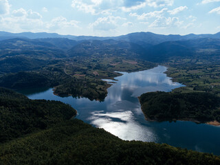 Aerial view of Rovni Lake reservoir and surrounding hilly landscape in Serbia. g.