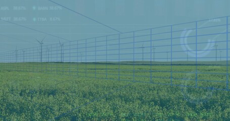 Displaying blue grid overlaying yellow field at farmland, with wind turbines and data graphs